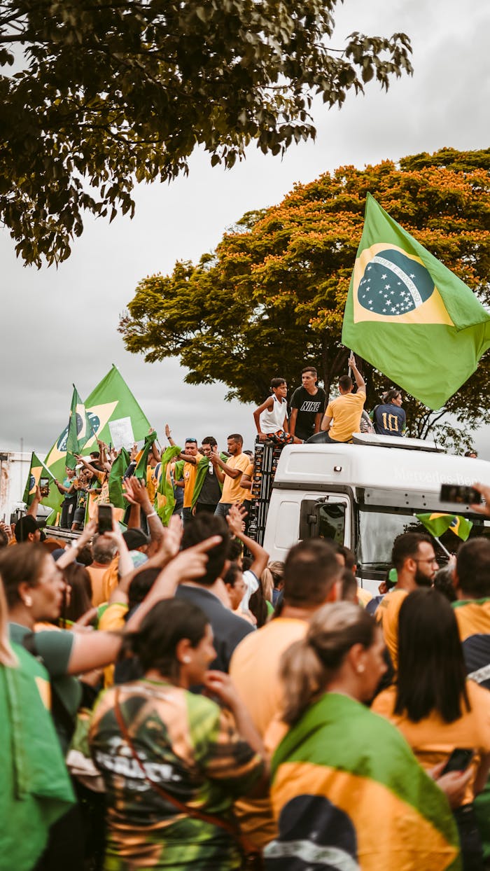 A peaceful street demonstration in Brazil with people holding national flags.
